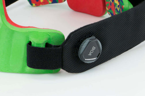 Pectus brace female with green panels and red foam. Close BOA Strap view